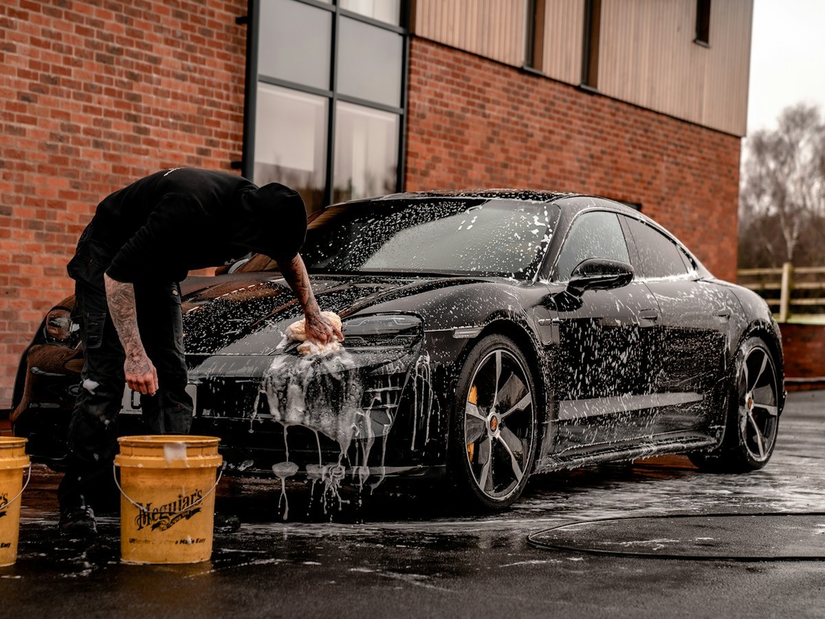 Hand wash detailing on a black luxury car